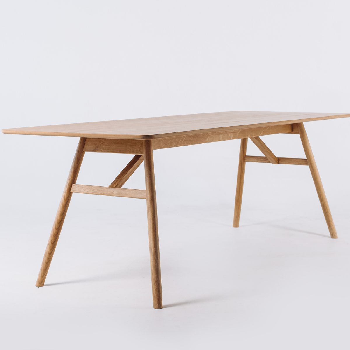Handmade Scandinavian rectangular oak dining table from Ukraine on white background